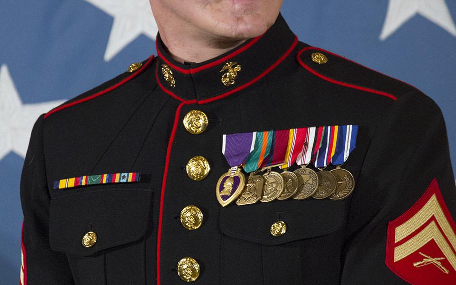 Retired Marine Corps Cpl. Kyle Carpenter listens as President Barack Obama talks about him during the Medal of Honor ceremony at the White House, June 19, 2014.