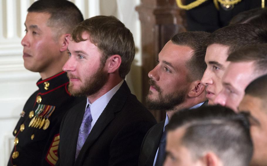 Marines listen as President Barack Obama talks about Cpl. Kyle Carpenter at the White House, June 19, 2014.
