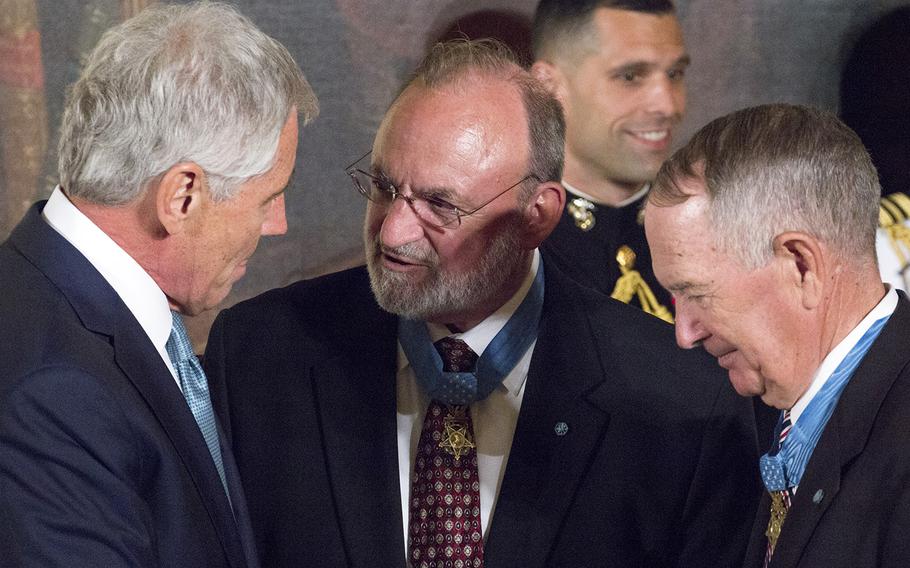 Secretary of Defense Chuck Hagel talks with Medal of Honor recipients and fellow Vietnam veterans Brian Thacker and Leo Thorsness before the Medal of Honor ceremony for retired Marine Corps Cpl. Kyle Carpenter at the White House, June 19, 2014.