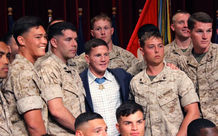 Medal of Honor recipient Cpl. William "Kyle" Carpenter poses for a unit photo with Camp Pendleton Marines on June 23, 2014 at the base theater. Carpenter told Marines he hopes to use the medal to bring awareness to the Marine Corps, wounded warriors and the fallen. 