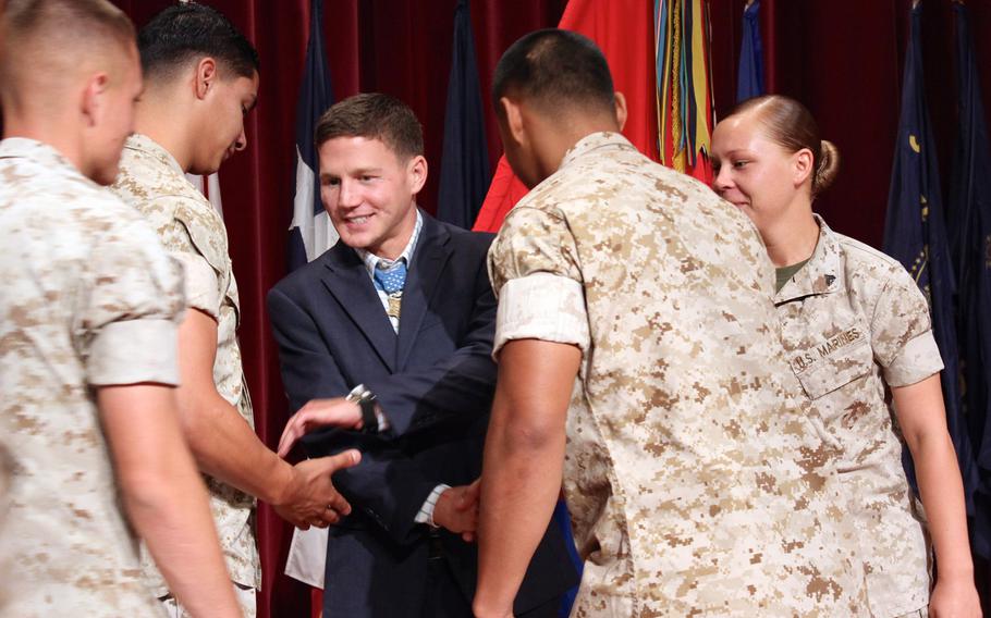 Medal of Honor recipient Marine Cpl. William "Kyle" Carpenter shakes hands with Marines at Camp Pendleton on June 23, 2014. Carpenter spoke to about 1,100 enlisted Marines at the base theater, telling them that he wears the medal for all of them. 