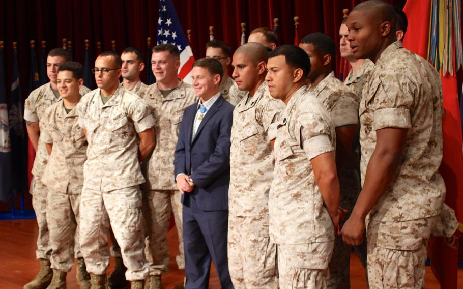 Medal of Honor recipient Cpl. William "Kyle" Carpenter poses for a unit photo with Camp Pendleton Marines on June 23, 2014 at the base theater. Carpenter told Marines he hopes to use the medal to bring awareness to the Marine Corps, wounded warriors and the fallen. 