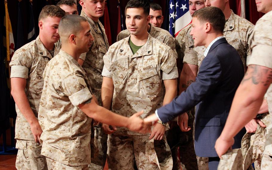 Medal of Honor recipient Cpl. William "Kyle" Carpenter shakes hands with Marines on June 23, 2014 at the Camp Pendleton theater. "I got a grenade thrown at me," he told the Marines. "Now I'm just trying to do good things." 