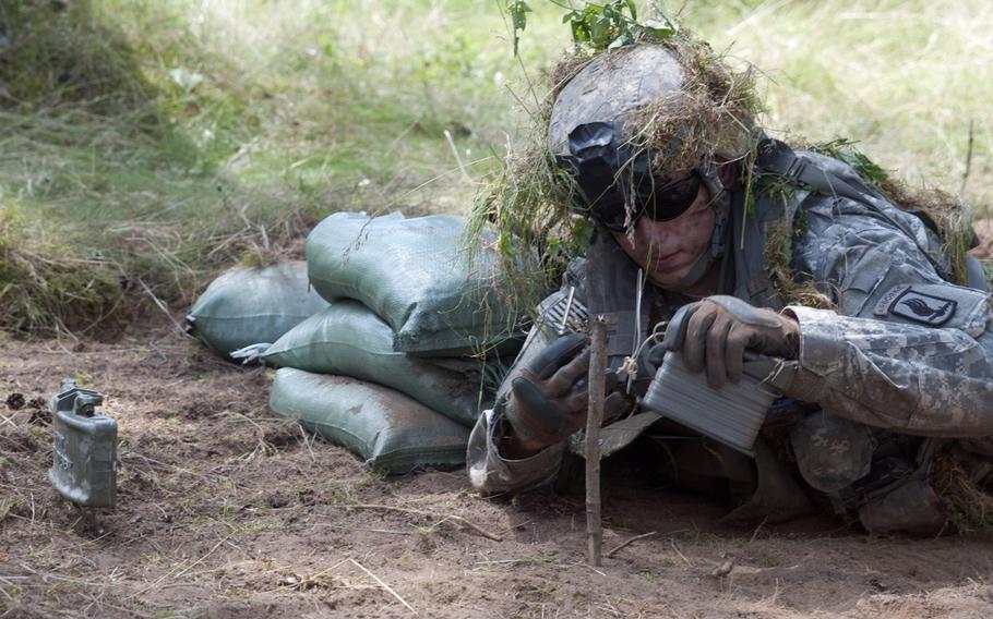 Spc. Kevin Crosby, a fire team leader with the 173rd Airborne Brigade, prepares a Claymore mine during a live-fire ambush range on June 17, 2014, at Drawsko-Pomorskie, Poland.