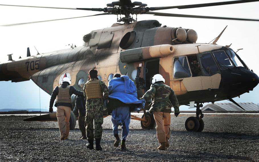 Afghan National Police officers wounded during insurgent attacks prepare to board an Mi-17 helicopter operated by the 2nd Wing of the Afghan National Army Air Force at Multinational Base Tarin Kowt in Uruzgan province, Afghanistan, Feb. 23, 2013. 