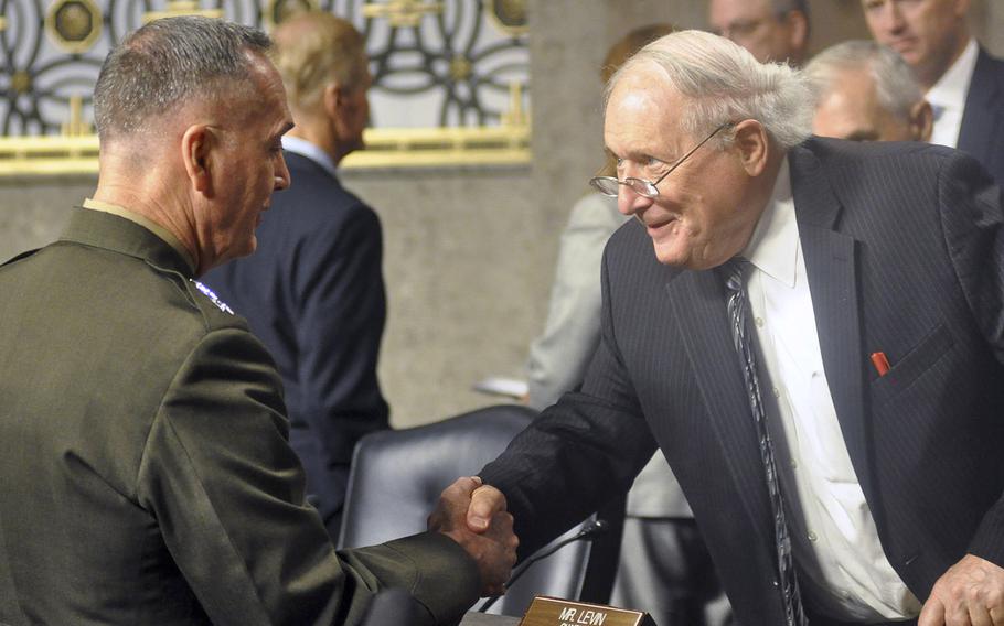 Marine Corps Gen. Joseph F. Dunford, Jr., shakes hands with Sen. Carl Levin, D-Mich., during a U.S. Senate hearing on Capitol Hill in Washington on Thursday, July 17, 2014. Members of the Committee on Armed Services, of which Levin is the chairman, were considering Dunford's nomination to be the next Commandant of the Marine Corps.
