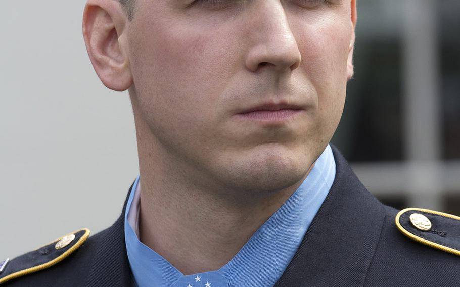 Former Army Staff Sgt. Ryan Pitts talks to reporters after his Medal of Honor ceremony at the White House, July 21, 2014.