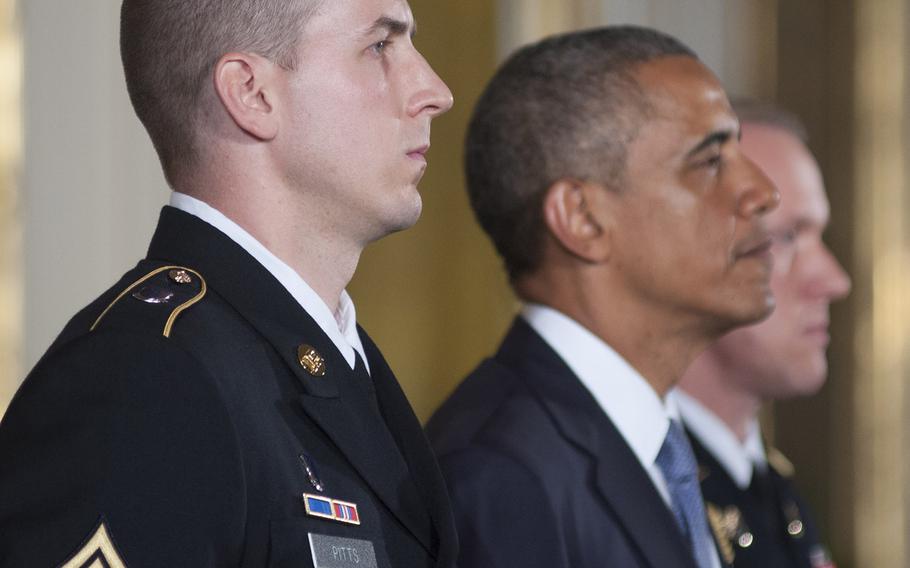 Former Army Staff Sgt. Ryan Pitts and Pesident Barack Obama listen as Pitt's Medal of Honor citation is read during the ceremony for  at the White House, July 21, 2014.