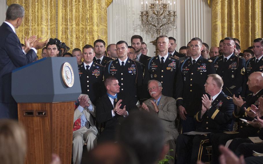 President Barack Obama, Medal of Honor recipients and military leaders applaud as members of former Army Staff Sgt. Ryan Pitts's unit are introduced during the ceremony at the White House, July 21, 2014.