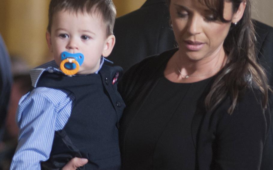 Former Army Staff Sgt. Ryan Pitts' wife Amy and son Lucas arrive for the Medal of Honor ceremony at the White House, July 21, 2014.