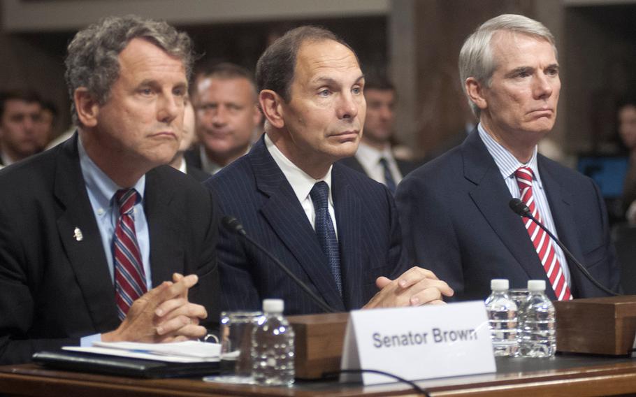 Secretary of Veterans Affairs nominee Robert McDonald is flanked by Ohio Sens. Sherrod Brown, left, and Rob Portman during his Senate Veterans Affairs Committee confirmation hearing, July 22, 2014.