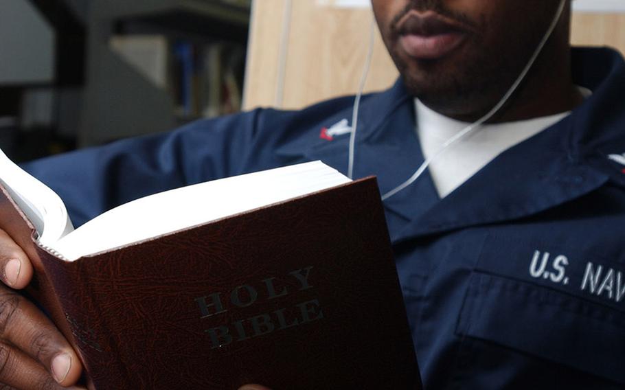 Petty Officer 3rd Class Matthew Smalls reads a bible in 2008. 