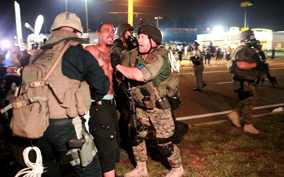 A protestor is arrested on W. Florissant Avenue during a clash with police on Monday, August 18, 2014 in Ferguson, Mo.