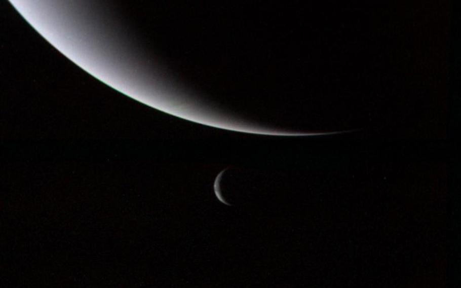A dramatic view of Neptune and moon Triton taken by Voyager 2 on Aug. 28, 1989.