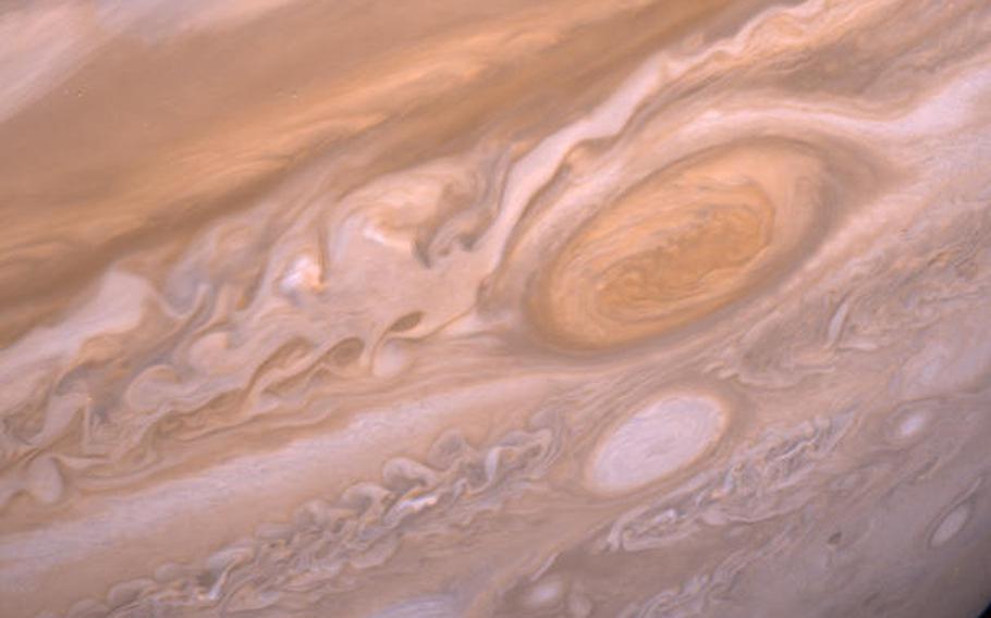 Two storm systems on Jupiter are in the frame of this 1979 photo taken by the Voyager 2 spacecraft. The larger, red spot is known was the Great Red Spot. 