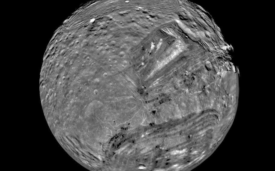 Miranda, the smallest of the five major satellites orbiting Uranus, is shown in this computer-assembled mosaic of images sent by the Voyager 2 spacecraft in early 1986. 