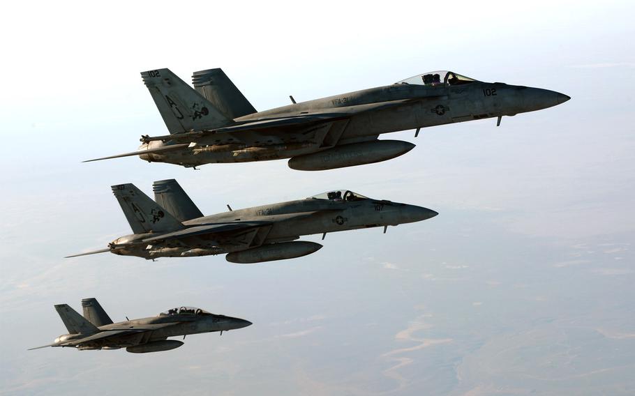 U.S. Navy F-18E Super Hornets leave after receiving fuel from a KC-135 Stratotanker over northern Iraq, on Sept. 23, 2014. These aircraft were part of a large coalition strike package that was the first to strike Islamic State militant targets in Syria.