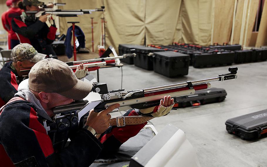 Jamie Sclater, a native to Annandale, Va., aims down range with other shooters during shooting practice for the 2014 Warrior Games. 