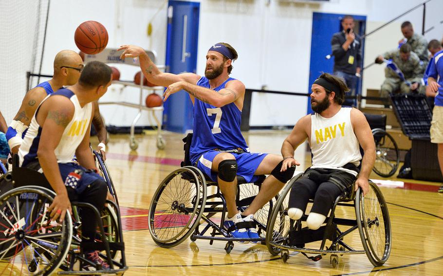 Retired Senior Airman Ryan Gallo makes a pass during the Air Force wheelchair basketball game against the Navy at the 2014 Warrior Games on Sept. 29, 2014, at the United States Olympic Training Center in Colorado Springs, Colo. The Air Force team lost 38-19.