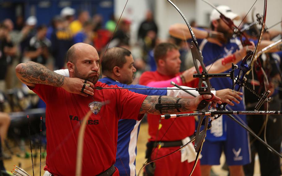 Sgt. Andres Burgos, from Orlando, Fla., prepares to send an arrow downrange toward his target during the archery competition at the 2014 Warrior Games. 