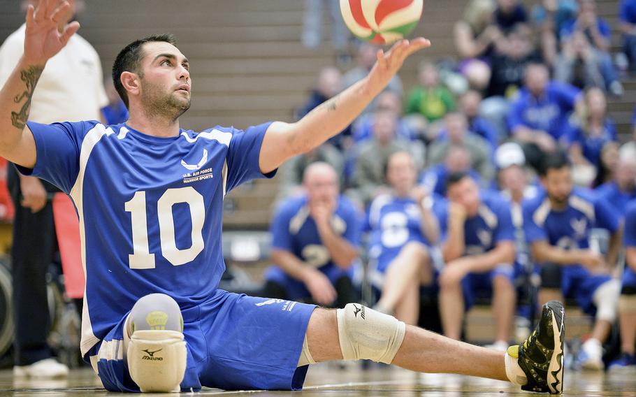 Retired Air Force Staff Sgt. Nicholas Dadgostar serves the ball during the sitting volleyball bronze medal match between the Air Force and the Army at the U.S. Olympic Training Center in Colorado Springs, Colo., on Oct. 1. The Army beat the Air Force in two sets, 25-20 and 25-19. 