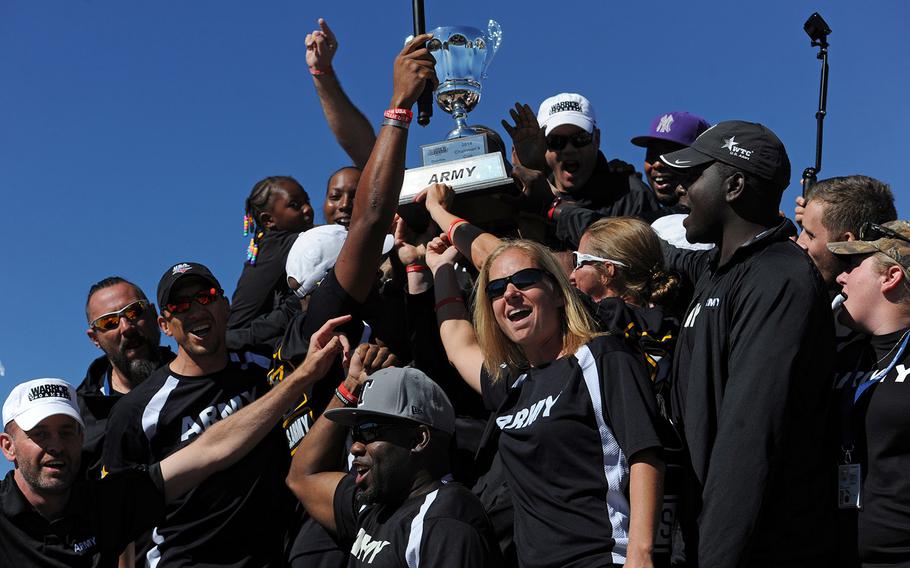 Team Army raises the 2014 Warrior Games Chairman's Cup during a tailgate party for wounded warriors before the Navy versus Air Force football game at the Air Force Academy in Colorado Springs, Colo., on Oct. 4, 2014.