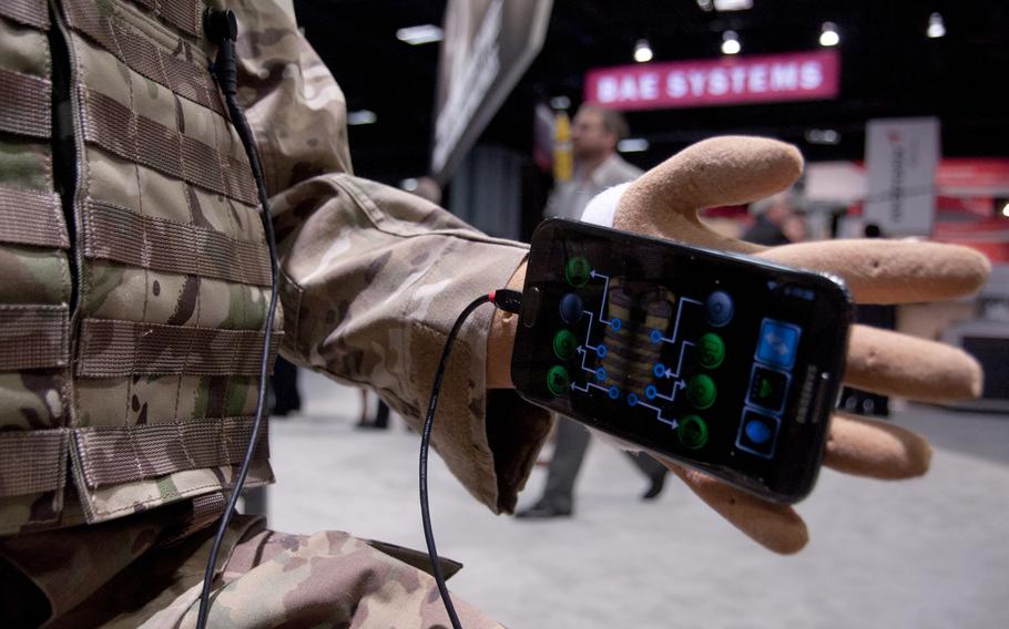 The Broadsword Soldier System suit by BAE Systems on display at AUSA 2014 in Washington, D.C. on Oct. 15. The suit is designed to eliminate the need for carrying batteries and other equipment by using a fabric that conducts electricity and transmits data without cords. Troops can recharge equipment by plugging into the suit. The Army and the Marine Corps both are evaluating the system, according to BAE.