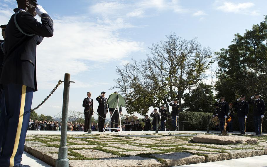 Servicemembers encircle JFK's grave site at a Wreath Laying Ceremony on Oct. 21, 2014. At the wreath are Secretary of the Army John McHugh, Brig. Gen. Darsie Rogers and Kennedy's nephew William Kennedy Smith. 