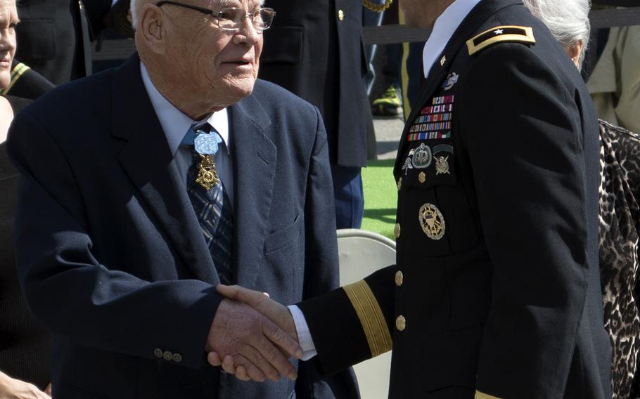Medal of Honor recipient and Vietnam veteran Bennie Adkins shakes the hand of a Green Beret following the Wreath Laying Ceremony at JFK's grave at Arlington National Cemetery on Oct. 21, 2014.