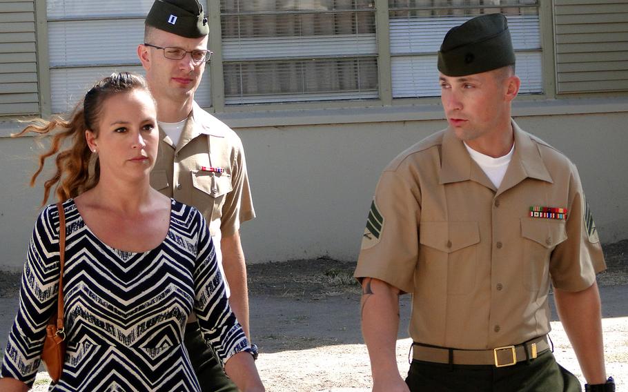 Sgt. Lawrence G. Hutchins III and his wife, Reyna, walk into a pre-trial hearing Thursday, Oct. 30, 2014 at Camp Pendleton. Hutchins served six years of an 11-year sentence for the 2006 killing of an unarmed Iraqi man before his conviction was overturned. He will be retried in January, 2015.
