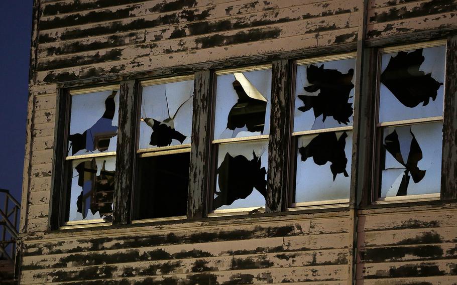 Dusk falls on the shattered windows of the reemployment center at the former Mare Island Naval Shipyard in Vallejo, Calif., Oct. 2, 2014. The shipyard dates from the 1850s and was the first U.S. Navy base in the Pacific. At its peak in World War II some 50,000 worked on the island. Today about 4,000 either work, live or go to school there. A number of its buildings and facilities are still empty following the closing of the shipyard in 1996. The building is to be demolished soon.