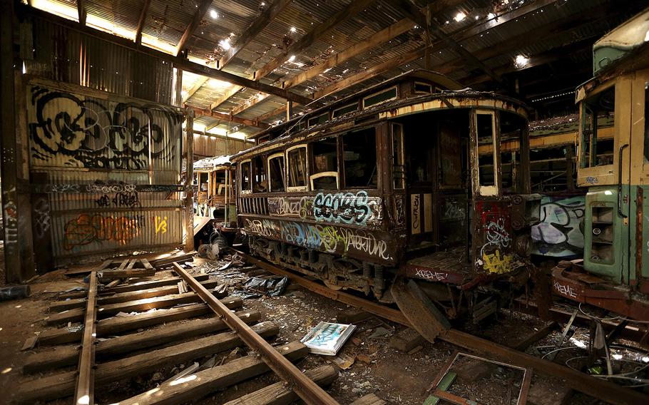 In this Oct. 22, 2014 photo, old tramcars and trolley buses sit abandoned and wrecked in the Loftus Tram Shed in Sydney. Trams became a key part of life in Sydney after the network was installed in 1879, with 1,600 cars in service during the height of its popularity. The service was eventually shut down in 1961. 