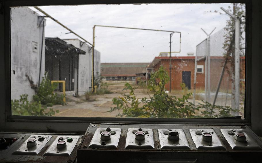 In this Oct. 23, 2014, photo, buttons that used to open and close many of the gates sit with a view of some of the out buildings at the abandoned Central State Farm prison in Sugar Land, Texas. The unit was closed down three years ago.