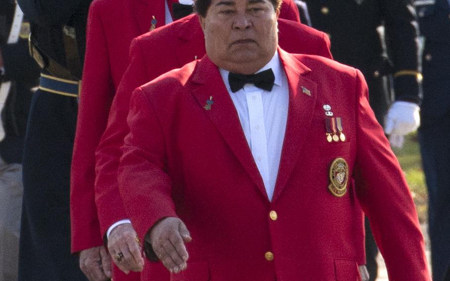 Marine veteran Jose Ramon Rodriguez precedes the casket of his uncle, Army Pvt. Miguel A. Vera, at Arlington National Cemetery on Nov. 20, 2014. Vera, who was killed during the Korean War, was one of 24 soldiers awarded the Medal of Honor in March after being previously overlooked because of their ethnic or racial backgrounds. Vera was originally buried in Puerto Rico.