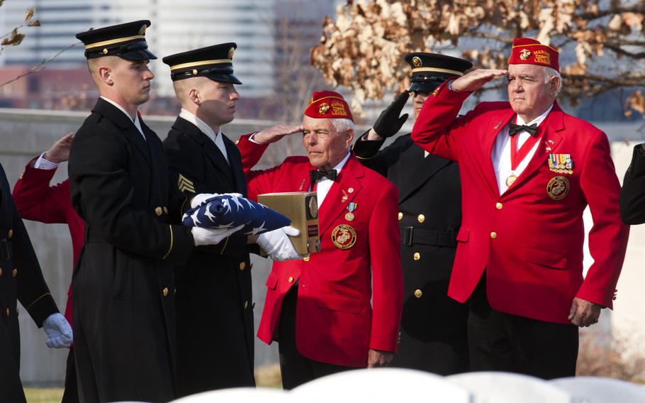 Marine veterans salute as an honor guard carries the ashes of Army Pvt. Miguel A. Vera at a burial ceremony at Arlington National Cemetery on Nov. 20, 2014. Vera, who was killed in the Korean War, was one of 24 soldiers awarded the Medal of Honor in March after being previously overlooked because of their racial or ethnic backgrounds. Vera was originally buried in Puerto Rico.