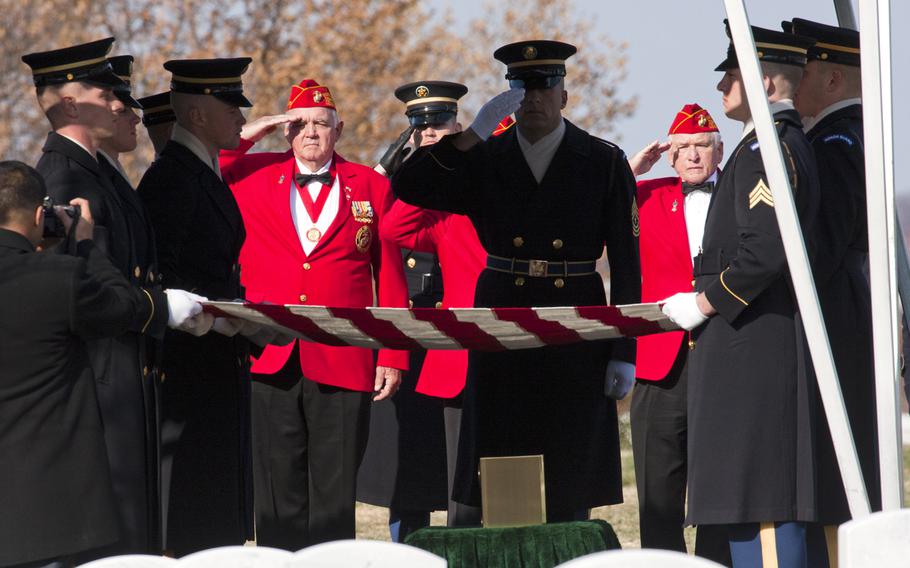 An honor guard holds a flag over the ashes of Army Pvt. Miguel A. Vera during a burial ceremony at Arlington National Cemetery on Nov. 20, 2014. Vera, who was killed in the Korean War, was one of 24 soldiers awarded the Medal of Honor in March after being previously overlooked because of their racial or ethnic backgrounds. Vera was originally buried in Puerto Rico.