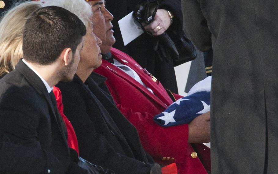 Marine veteran Jose Ramon Rodriguez accepts a folded flag during a burial service for his uncle, Army Pvt. Miguel A. Vera, at Arlington National Cemetery on Nov. 20, 2014. Vera, who was killed in the Korean War, was one of 24 soldiers awarded the Medal of Honor in March after being previously overlooked because of his ethnicity. Vera was originally buried in Puerto Rico.