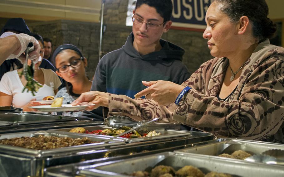 Guests receive their dinner at the USO in Bethesda, Md., during the Make a Moment Campaign, on Nov. 20, 2014.