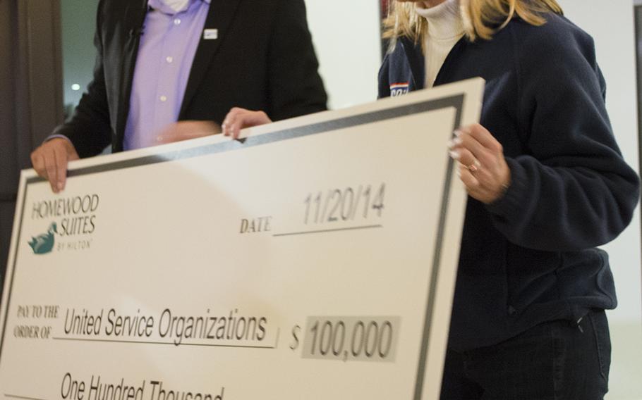 Vice President of Marketing for Homewood Suites Christian Kuhn donates $100,000 to the USO as part of the Make a Moment Campaign at the USO in Bethesda, Md., on Nov. 20, 2014.