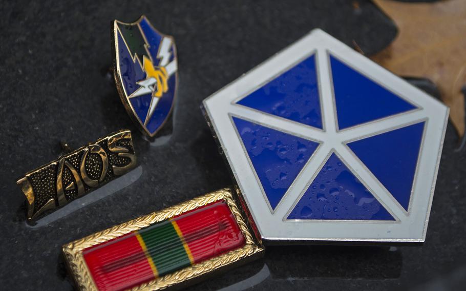 A collection of small mementos lie in water at the Vietnam Veterans Memorial as the D.C. area was pelted with rain and snow on Wednesday, Nov. 26, 2014.