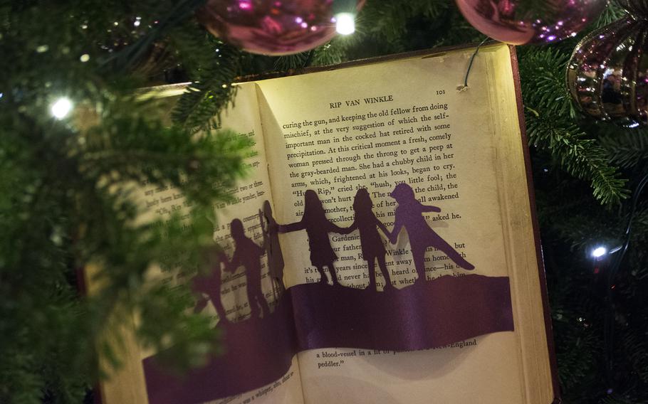 A re-purposed book hangs as an ornament in the East Room of the White House on Dec. 3, 2014.