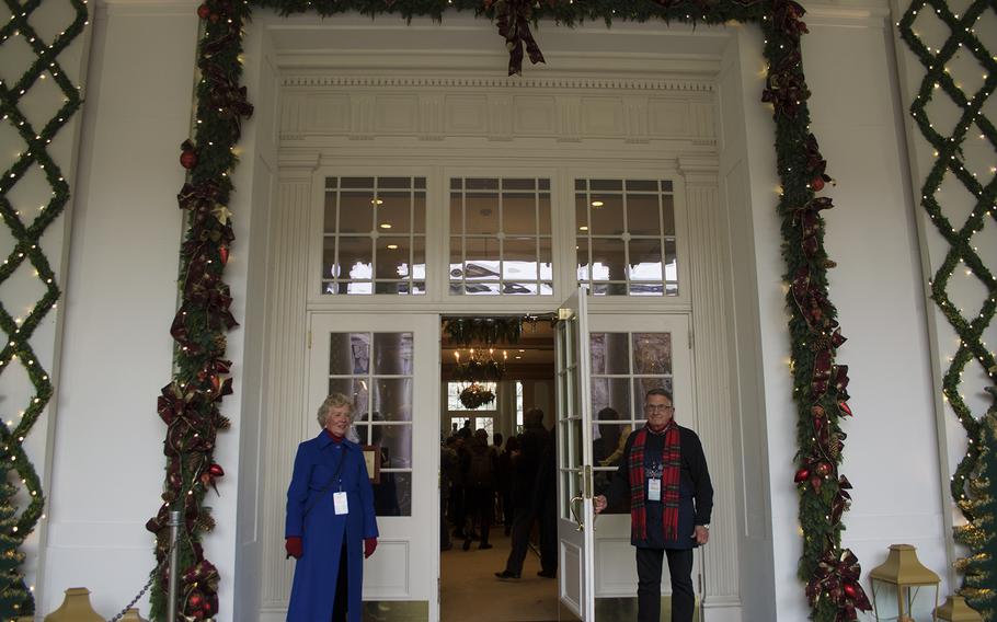 Volunteers stand ready to welcome guests at the East Visitor Entrance of the White House on Dec. 3, 2014. 