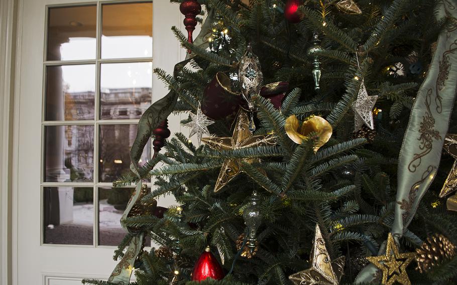 A Christmas tree near the entrance of the East Visitor Entrance of the White House on Dec. 3, 2014. The U.S. Dept. of The Treasury is reflected in the window. 