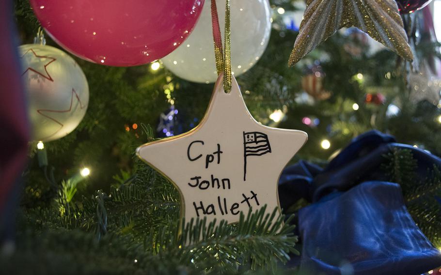 A gold star hangs from the Gold Star Tree in an area of the White House dedicated to servicemembers and their families. The ceramic star ornament is signed by Gold Star families. 