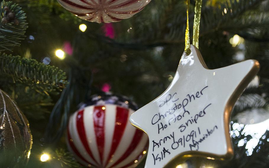 A gold star hangs from the Gold Star Tree in an area of the White House dedicated to servicemembers and their families. The ceramic star ornament is signed by Gold Star families.