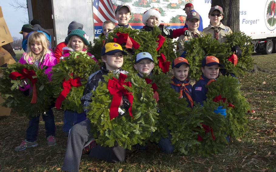 Cub Scouts from Pack 42 in Charles Town, W. Va., prepare to place wreaths during Wreaths Across America at Arlington National Cemetery, Dec. 13, 2014.
