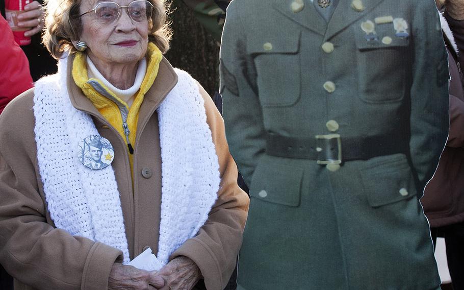 Edith Nowels, a director of Wreaths Across America, stands at Arlington National Cemetery next to a cutout image of her brother, World War II Medal of Honor recipient Horace "Bud" Thorne, Dec. 13, 2014.
