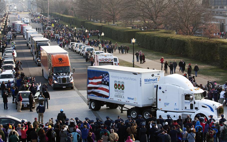 Trucks bearing wreaths from Maine arrive at Arlington National Cemetery for Wreaths Across America, Dec. 13, 2014.
