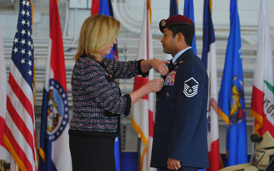 Secretary of the Air Force Deborah Lee James pins the Air Force Cross to the uniform of Master Sgt. Ivan Ruiz, a pararescueman from the 56th Rescue Squadron, Royal Air Force Lakenheath, England, during a ceremony at the Freedom Hangar on Hurlburt Field, Fla., Dec. 17, 2014. While deployed to Afghanistan with the 22nd Expeditionary Special Tactics Squadron, Ruiz protected his injured special operations forces teammates with fire support and provided emergency medical care under intense enemy fire in the dark, Dec. 10, 2013.