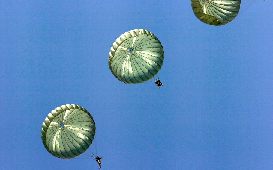 Paratroopers from the 82nd Airborne's 3rd Brigade Combat Team and Division Special Troops Battalion exit an Air Force C-130 during a jump at Fort Bragg's Sicily Drop Zone, July 14, 2010.